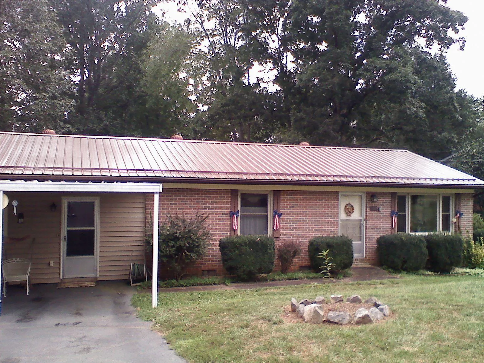 Bronze metal roof and carport on a brick ranch home — Roof Repair work by our crew in North Attleboro