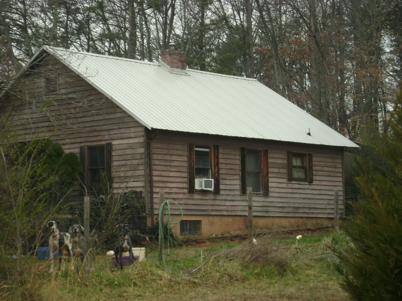 White metal roof on an old wood sided farmhouse, from a Metal Roof Installation job in North Attleboro